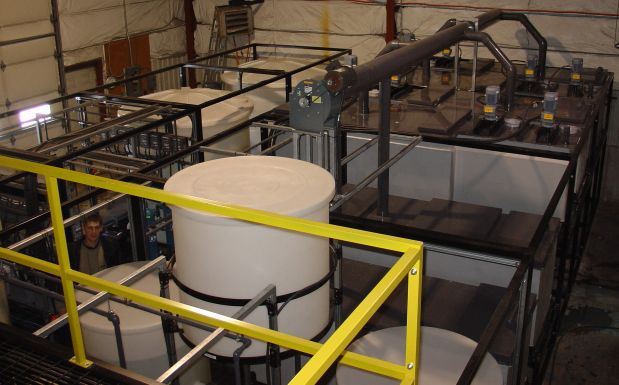 Modular solvent extraction pilot plant complete with mixer-settlers, feed tanks, coalescer, organic tank, crud treatment, and process control instrumentation.
