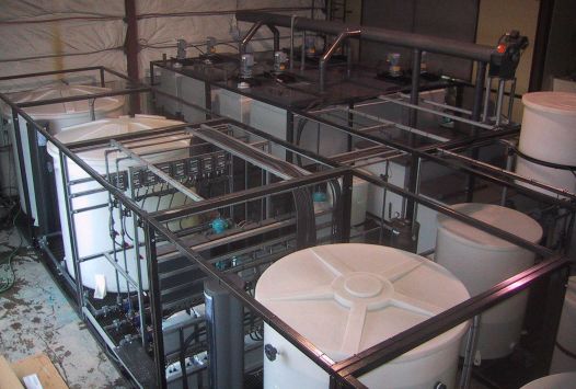 Modular solvent extraction pilot plant complete with mixer-settlers, feed tanks, coalescer, organic tank, crud treatment, and process control instrumentation.